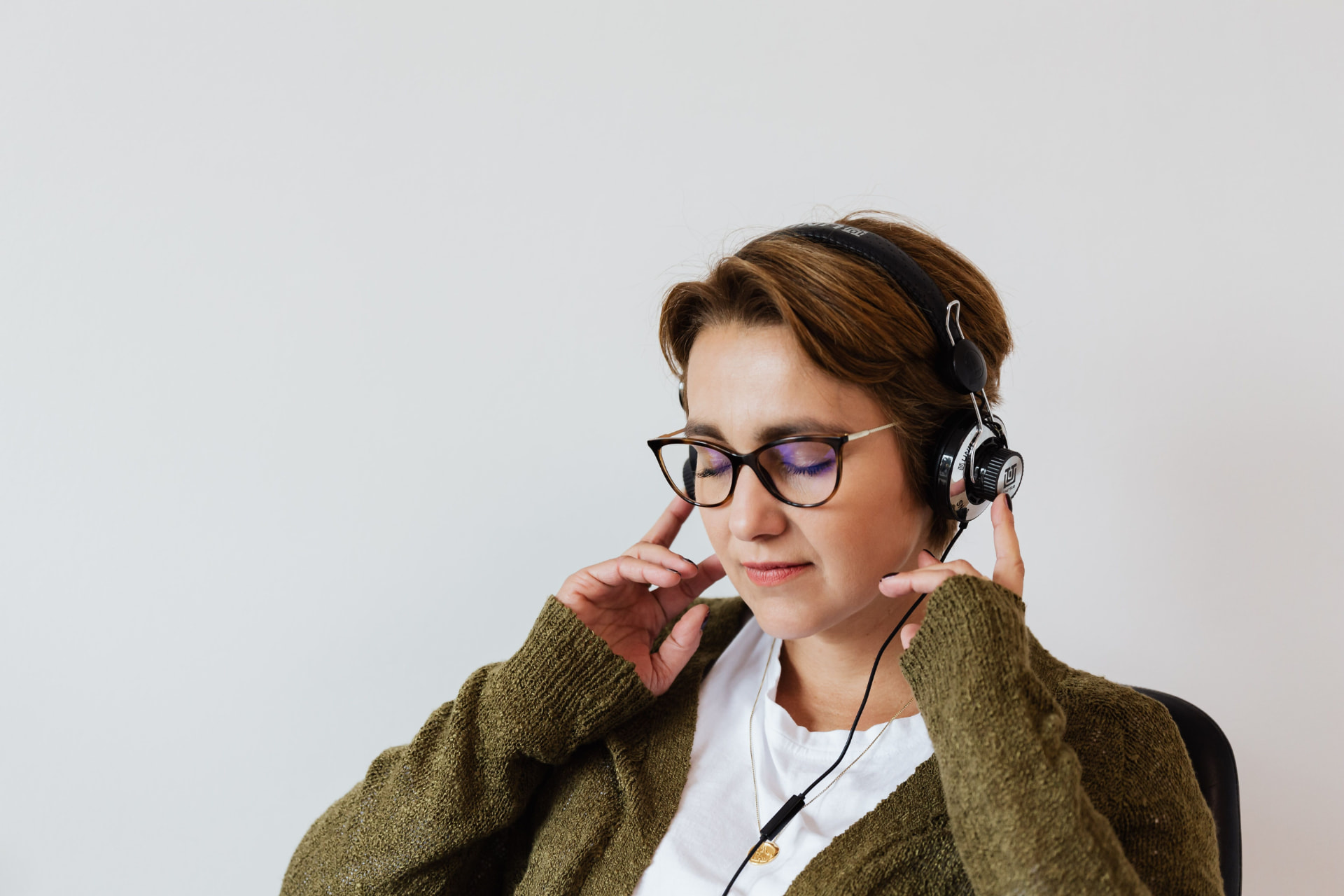 Woman listening to The Lady Garden podcast with headphones